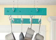 <body> <p>Keep your loftiest cooking ideas—and essentials—within reach with this alluring overhead pot rack. Painted poplar boards fixed with <a rel="nofollow noopener" href=" http://www.bobvila.com/slideshow/if-this-then-that-your-guide-to-pairing-paint-colors-49511?bv=yahoo" target="_blank" data-ylk="slk:color-complementary;elm:context_link;itc:0;sec:content-canvas" class="link ">color-complementary</a> dowels form the frame of the rack, while a chain securely hangs it in place from the ceiling—helping you bid cabinet clutter goodbye!</p> <p><strong>Related: <a rel="nofollow noopener" href=" http://www.bobvila.com/slideshow/18-clever-storage-solutions-you-can-diy-for-free-49712?bv=yahoo" target="_blank" data-ylk="slk:18 Clever Storage Solutions You Can DIY for Free;elm:context_link;itc:0;sec:content-canvas" class="link ">18 Clever Storage Solutions You Can DIY for Free</a> </strong> </p> </body>