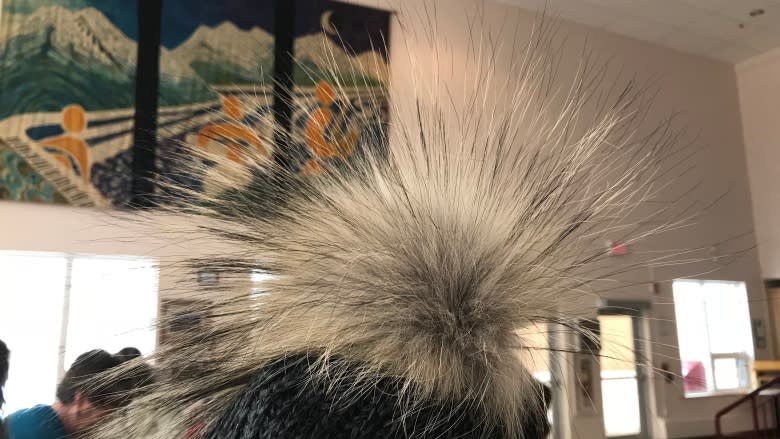 Volunteers make wolf fur pompoms for Yukon's Arctic Winter Games athletes