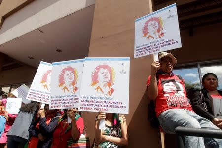 Lenca indigenous hold placards during a protest to mark the second anniversary of the killing of environmental activist Berta Caceres, in Tegucigalpa, Honduras March 2, 2018. REUTERS/Jorge Cabrera