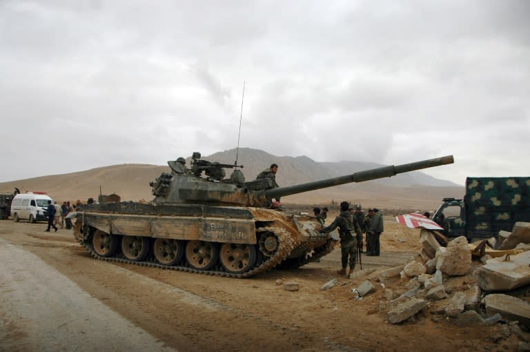 Syrian regime fighters take position as they advance to retake the ancient city of Palmyra, from Islamic State (IS) group fighters on March 2, 2017