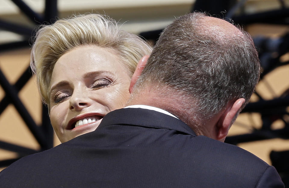 Princess Charlene of Monaco and Prince Albert II of Monaco embrace during celebrations marking Prince Albert II's decade on the throne, Saturday, June 11, 2015 at Monaco's palace.  On 31 March 2005, the Palace of Monaco announced that Hereditary Prince Albert would take over the duties of his father as regent since Rainier was no longer able to exercise his functions as sovereign. On 6 April 2005, Prince Rainier III died and Hereditary Prince Albert became Albert II, Sovereign Prince of Monaco. REUTERS/Lionel Cironneau/Pool