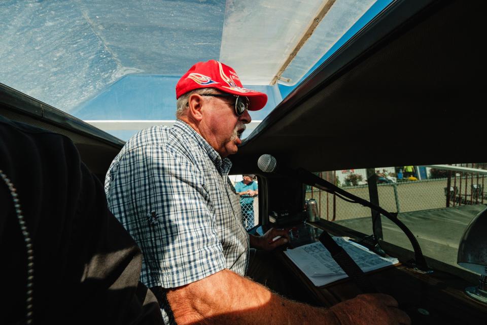 Mike Woebkenberg, of Woebkenberg Starting Gates, based in West Alexandria, Ohio, issues starting orders to harness racers during the Tuscarawas County Fair, Friday, Sept. 22 in Dover. He said his company does about 3,800 races per year.