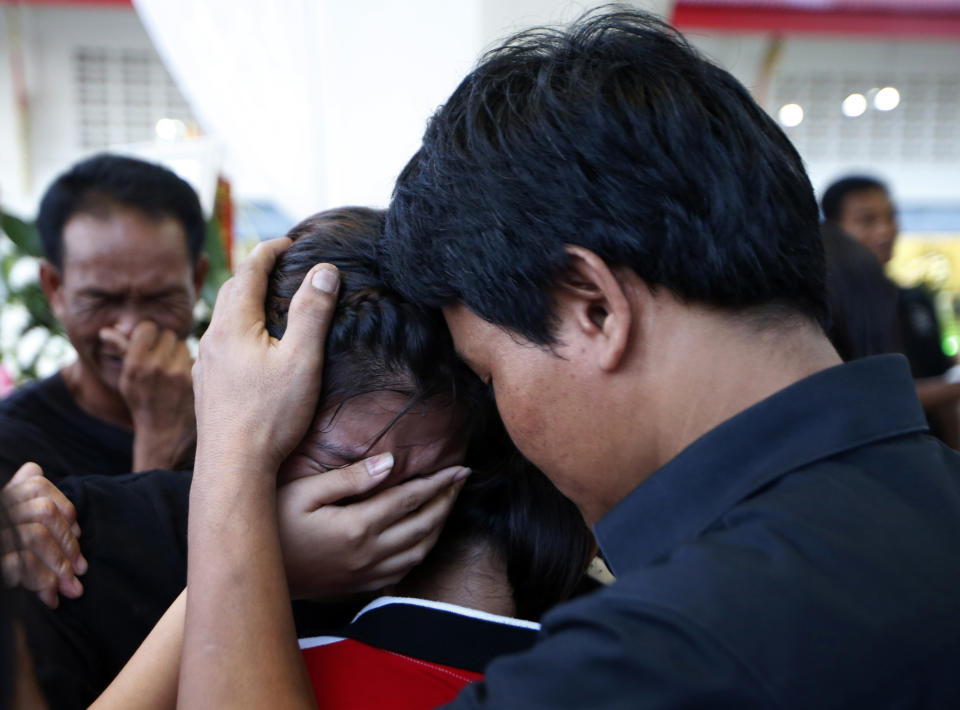 In this Thursday, Nov. 15, 2018, photo, relatives of 13-year-old Thai kickboxer Anucha Tasako cry during his funeral services at a Buddhist temple in Samut Prakan province, Thailand. Anucha died of a brain hemorrhage two days after he was knocked out in a bout on Nov. 10 that was his 174th match in the career he started at age 8. Thai lawmakers recently suggested barring children younger than 12 from competitive boxing, but boxing enthusiasts strongly oppose the change. (AP Photo/Sakchai Lalit)