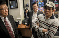 CORRECTS LAST NAME TO CHU NOT CHUN - In this Feb. 13, 2020, photo, William Su, left, chairman of the Chinese Association of New York, John Lam, chairman America China Hotel Association, center, Frankie Chu, owner of Vegetarian Dim Sum House restaurant, meet in New York to discuss decline in Chinatown customers amid fears about the viral outbreak that originated in China. Chun said he will not be able to make his rent this month. (AP Photo/Bebeto Matthews)