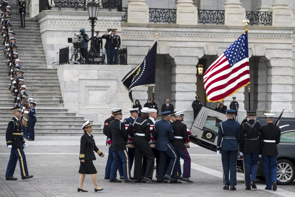 <p>A joint services military honor guard puts the casket into the hearse that will transport it from the U.S. Capitol to the Washington National Cathedral.</p>
