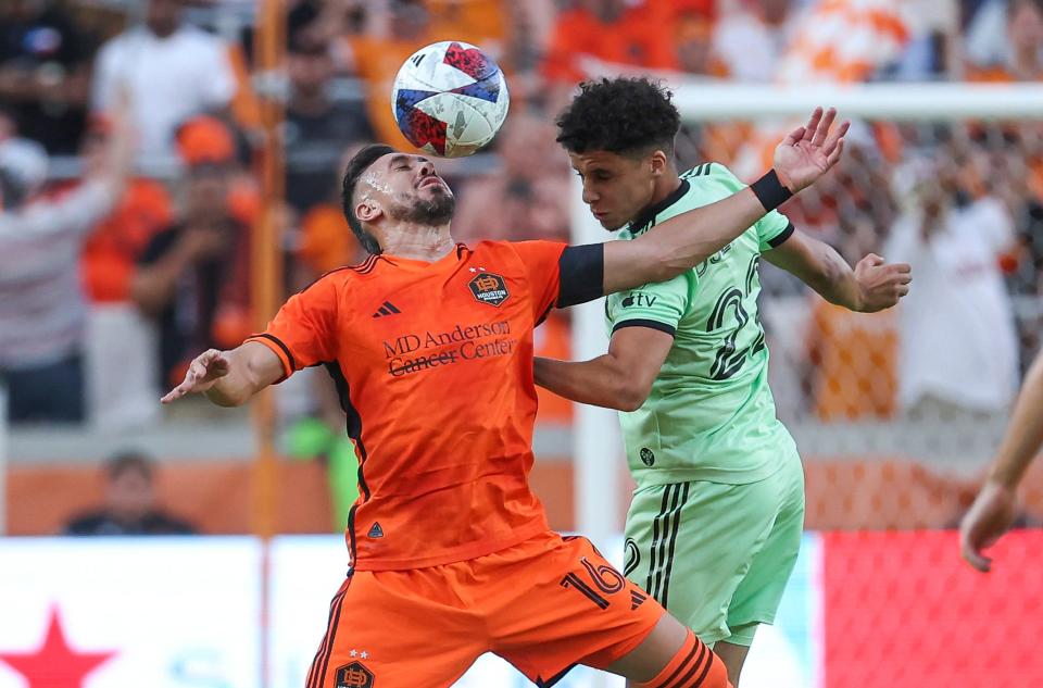 Austin FC midfielder Sofiane Djeffal, right, attempts to head the ball away from Houston Dynamo FC midfielder Hector Herrera during the first half of Saturday night's match at Shell Energy Stadium. Houston Dynamo FC won 2-1.