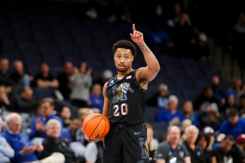 Memphis' Joe Cooper (20) signals to the bench while running down the clock with the ball during the game between the University of Charlotte and the University of Memphis at FedExForum in Memphis, Tenn., on Wednesday, February 21, 2024.