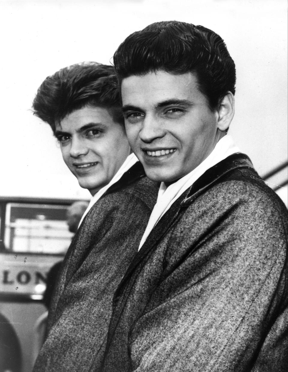 FILE - In this April 1, 1960 file photo, Phil, left, and Don of the Everly Brothers arrive at London Airport from New York to begin their European tour. Don Everly, one-half of the pioneering rock ‘n’ roll Everly Brothers whose harmonizing country rock hits impacted a generation of rock music, has died. He was 84. A family spokesperson said Everly died at his home in Nashville, Tennessee on Saturday, Aug. 21, 2021. (AP Photo, File)