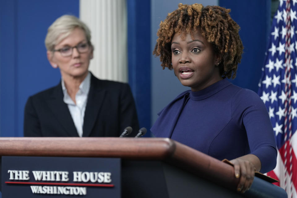 Energy Secretary Jennifer Granholm, left, listens as White House press secretary Karine Jean-Pierre, right, speaks during the daily briefing at the White House in Washington, Monday, Jan. 23, 2023. (AP Photo/Susan Walsh)