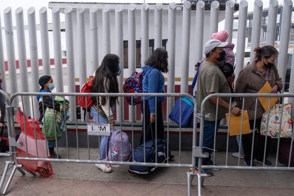 An asylum-seeker family from the Mexican state of Guerrero arrive for their appointment with U.S. authorities at the El Chaparral Port of Entry in Tijuana, Mexico, on May 12, 2023.  / Credit: GUILLERMO ARIAS/AFP via Getty Images