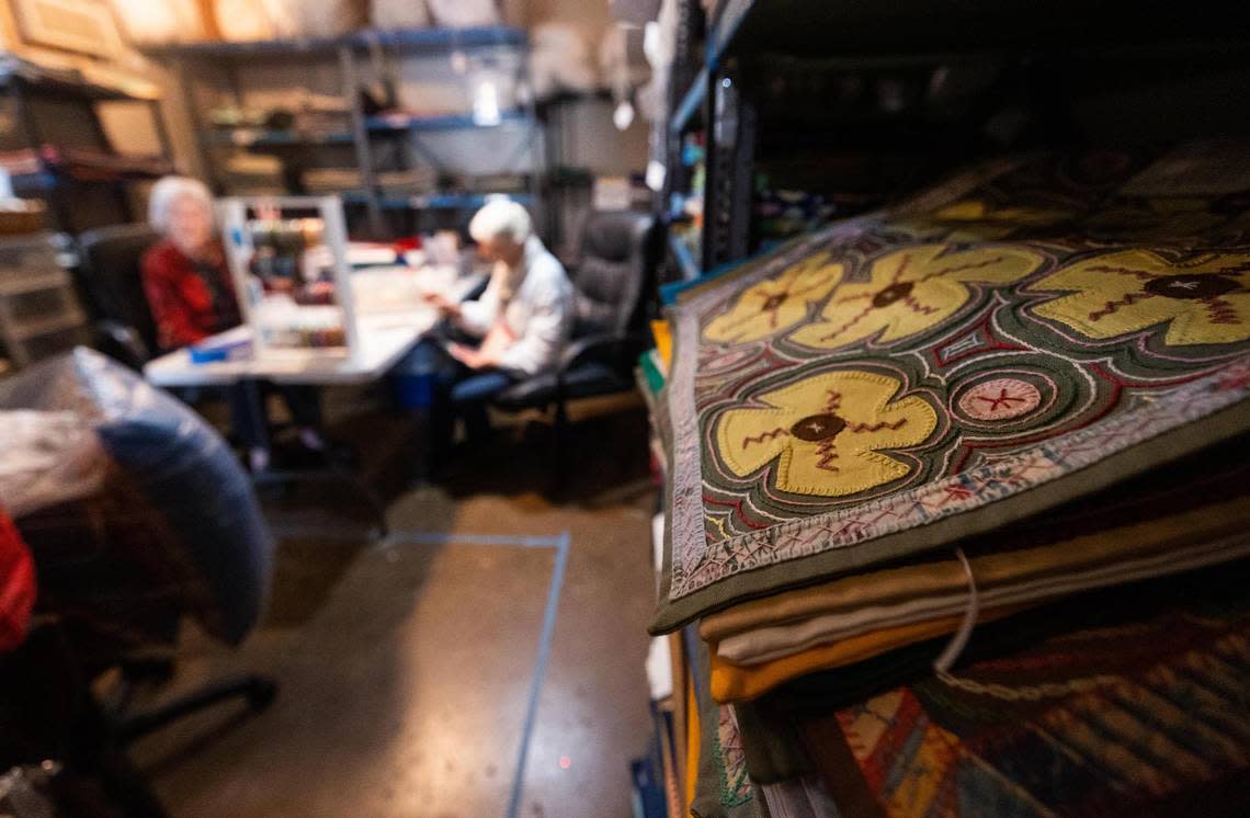 M’Lou Bancroft and Barbara Velhum sort through cards and embroidered cases for Honduras Threads Wednesday, Oct. 26, 2022, in Dallas. Honduras Threads works with women in Honduras who create the products for customers in United States.