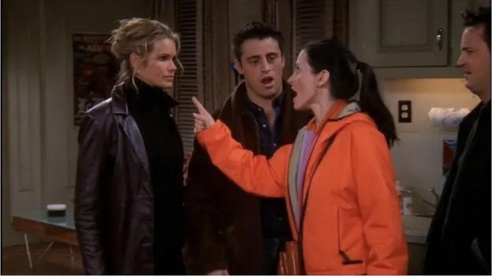 Monica pointing and yelling at Janine as Joey and Chandler look on