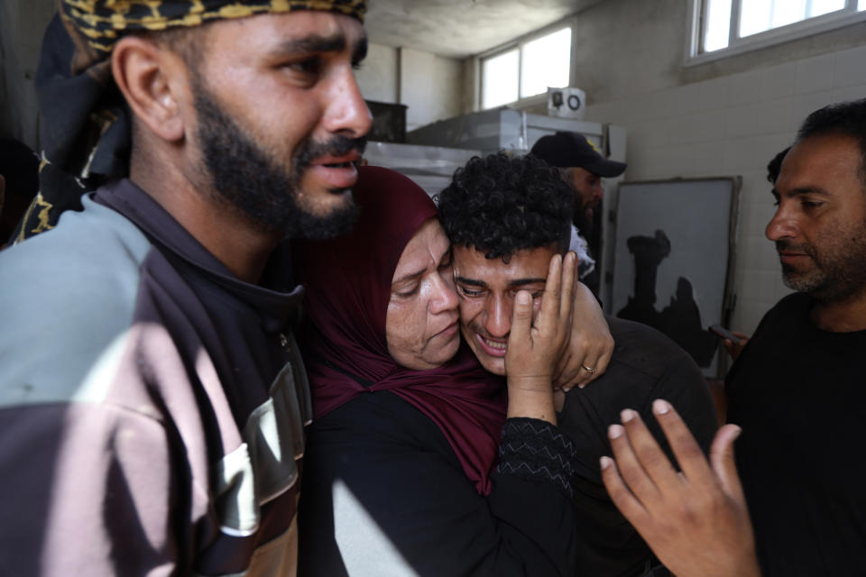 Palestinians mourn their relative Tamer Mohsen killed in the Israeli bombardment of Nuseirat refugee camp, at the morgue of al-Aqsa Martyrs hospital in Deir al Balah, central Gaza Strip, Wednesday, June 19, 2024. (AP Photo/Saher Alghorra)