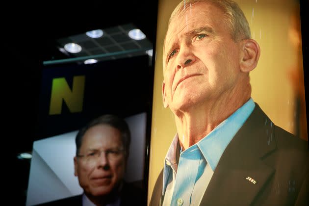 Photos of NRA CEO and Executive Vice President Wayne LaPierre (left) and former president of the NRA Oliver North (right) are on display during the third day of the National Rifle Association convention in 2019. (Photo: Jeremy Hogan/SOPA Images via Getty Images)