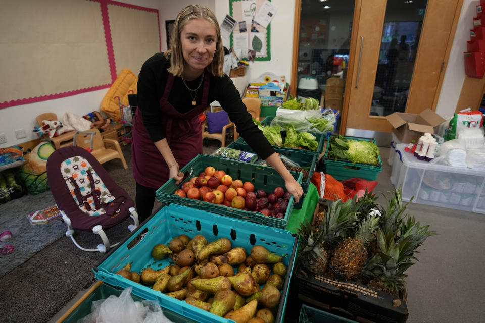 Anna Sjovorr-Packham prepares the food at the community food pantry in Vauxhall, London, Wednesday, Nov. 16, 2022. Just three weeks after taking office, British Prime Minister Rishi Sunak faces the challenge of balancing the nation's finances while helping millions of people slammed by a cost-of-living crisis as Russia's war in Ukraine pushes up energy prices and slows economic growth. Treasury chief Jeremy Hunt will deliver the government’s plan for tackling a sputtering economy in a speech to the House of Commons on Thursday. (AP Photo/Frank Augstein)