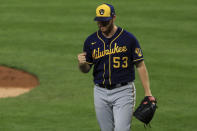 Milwaukee Brewers' Brandon Woodruff reacts to an inning-ending double play hit into by Cincinnati Reds' Jesse Winker in the fourth inning during a baseball game in Cincinnati, Monday, Sept. 21, 2020. (AP Photo/Aaron Doster)