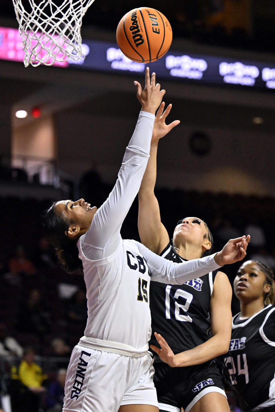 California Baptist guard Anaiyah Tu'ua (15) shoots as Stephen F. Austin guard Kyla Deck (12) defends during the first half of an NCAA college basketball game in the championship of the Western Athletic Conference women's tournament, Saturday, March 16, 2024, in Las Vegas. (AP Photo/David Becker)