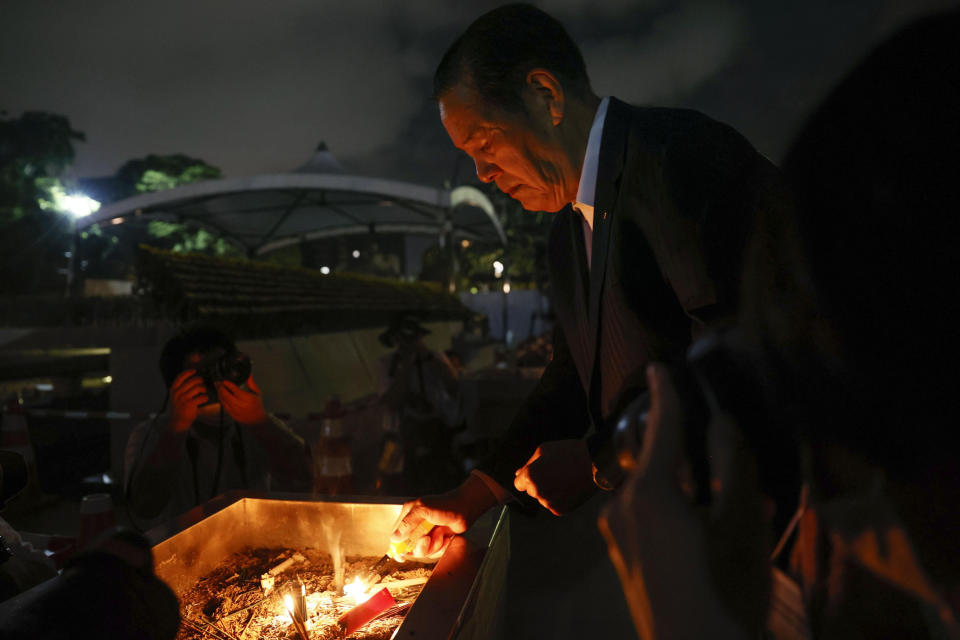 A visitor burns incense in front of the cenotaph dedicated to the victims of the atomic bombing at the Hiroshima Peace Memorial Park in Hiroshima, western Japan Saturday, Aug. 6, 2022. Hiroshima on Saturday marked the 77th anniversary of the world's first atomic bombing of the city. (Kyodo News via AP) /Kyodo News via AP)