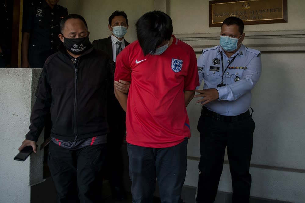 Khor Yong Zhang (centre) is led out of the Magistrate Court in Kuala Lumpur June 1, 2020. — Bernama pic