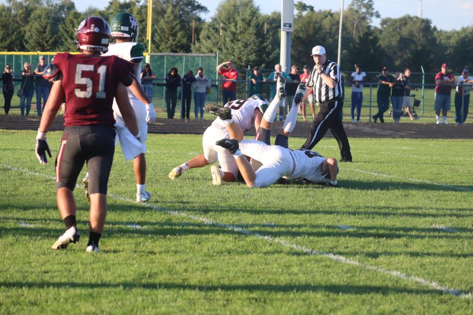 Oak Harbor's Jacob Ridener and Zach Clune force the quarterback to put his feet up.