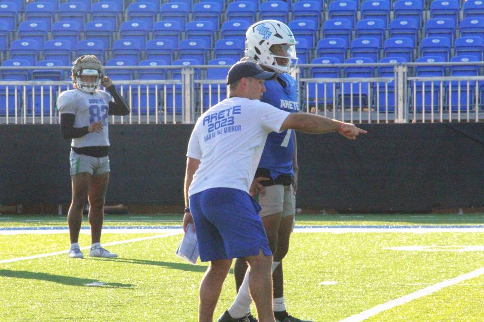 UWF football head coach Kaleb Nobles (front) explains a play to quarterback Peewee Jarrett during the Argos' practice on Wednesday, Sept. 6, 2023, at Pen Air Field.