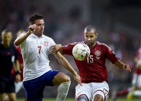 Denmark's Simon Poulsen (R) and Zoran Tosic of Serbia fight for the ball during their Euro 2016 qualifying match in Copenhagen, Denmark, June 13, 2015. REUTERS/Liselotte Sabroe/Scanpix Denmark