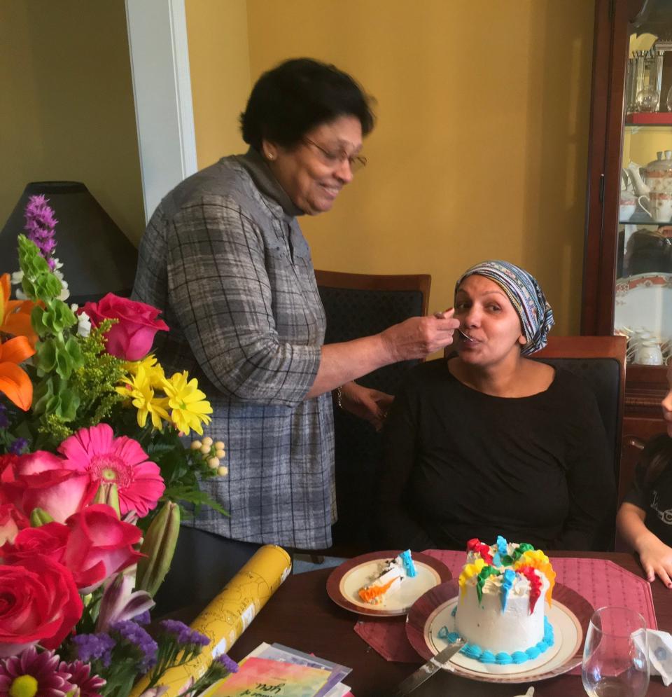 Geeta Prakash Desai feeds her daughter, Sveta Prakash Desai, a spoonful of birthday cake at their house in Troy in January 2020. It was Sveta's 37th birthday, and she was in the midst of chemotherapy to treat stage 3 breast cancer.