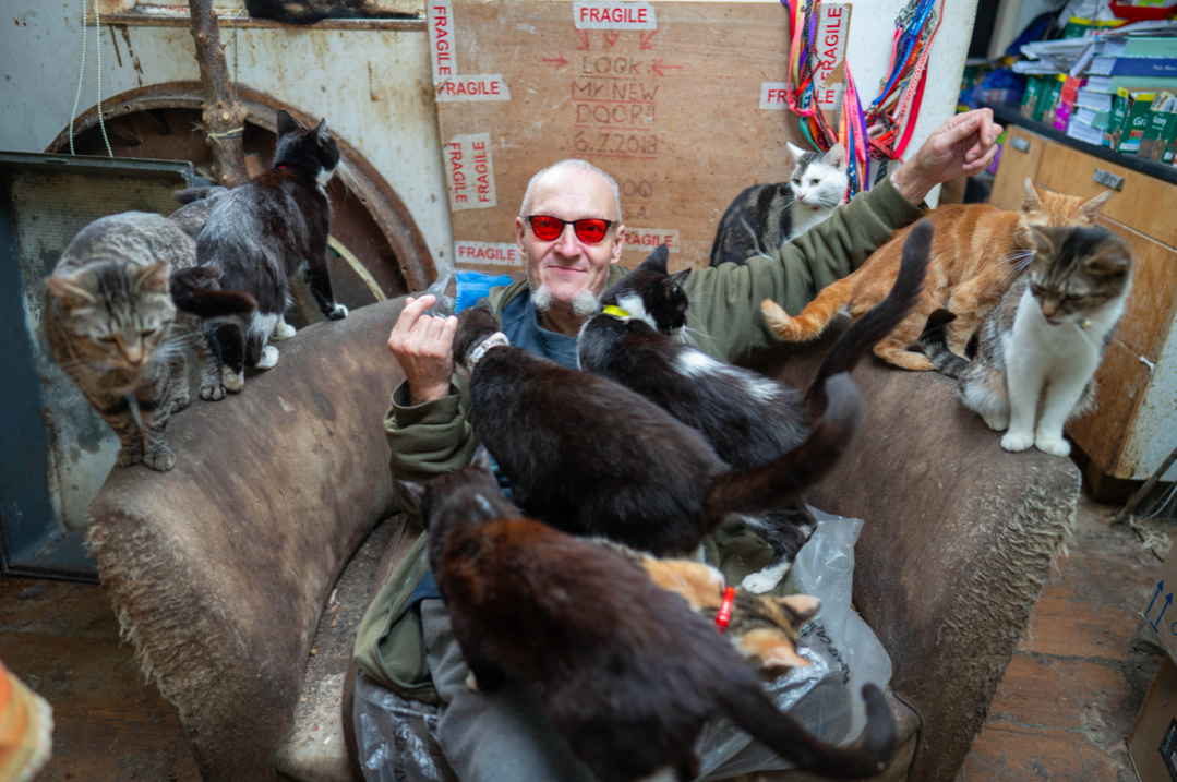 Cat lover Ian 'Catmando' lives with dozens of cats in a small terraced house and claims he trains them up to help people with epilepsy. (SWNS)