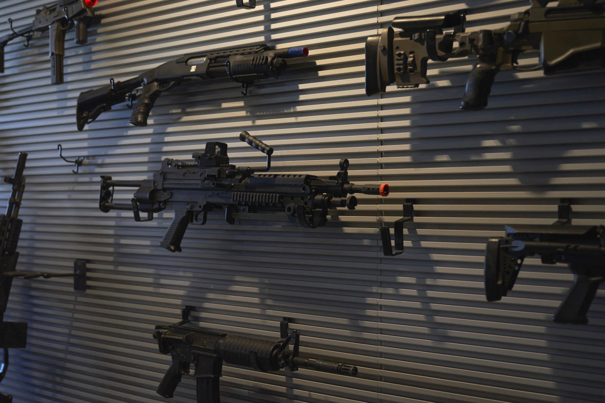 Guns for the video game series Call of Duty are displayed on a wall on Friday, Oct. 21, 2022, at Activision Blizzard, Infinity Ward Division, in Woodland Hills, Calif. Call of Duty has been one of the best-selling video games for the past decade-plus, and is at the heart of the developing antitrust fight over whether Microsoft will be able to acquire Activision Blizzard. (AP Photo/Allison Dinner)