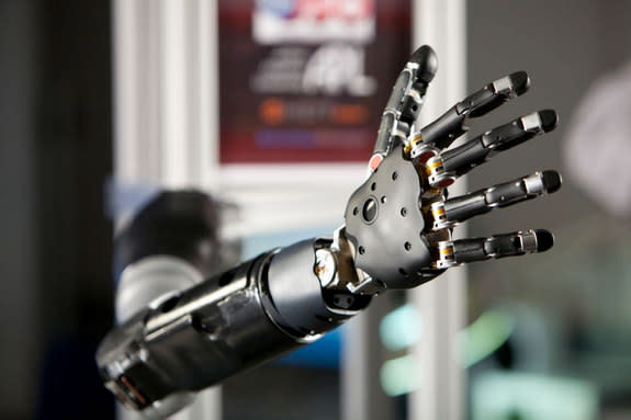 the prosthetic arm, designed by the John Hopkins University's Applied Physics Laboratory (JHU/APL) and funded by the U.S. Department of Defense's Defense Advanced Research Projects Agency (DARPA).