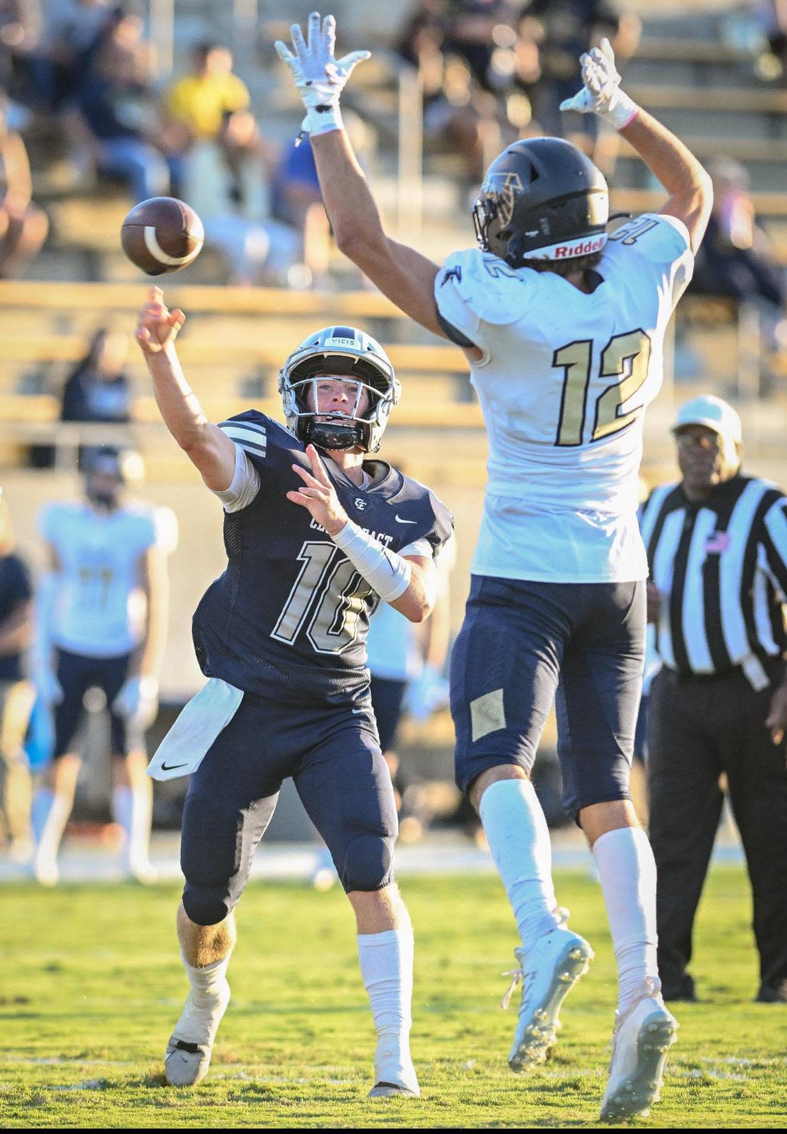 Clovis East quarterback Ty Miller, left, throws against the defense of Foothill’s Cade Nielson during their game at Lamonica Stadium on Friday, Aug. 18, 2023. CRAIG KOHLRUSS/ckohlruss@fresnobee.com