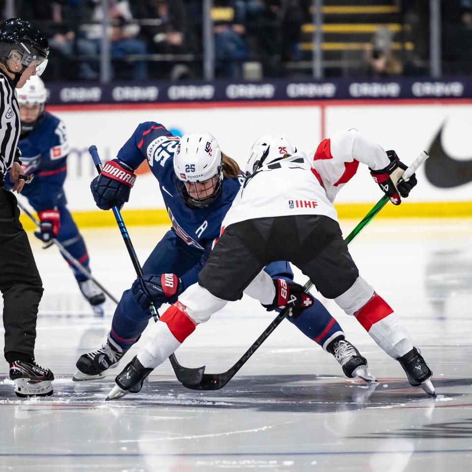 USA's Alex Carpenter and Switzerland's Alina Muller battle during a face-off at the Adirondack Bank Center in Utica, NY on Wednesday, April 3, 2024.