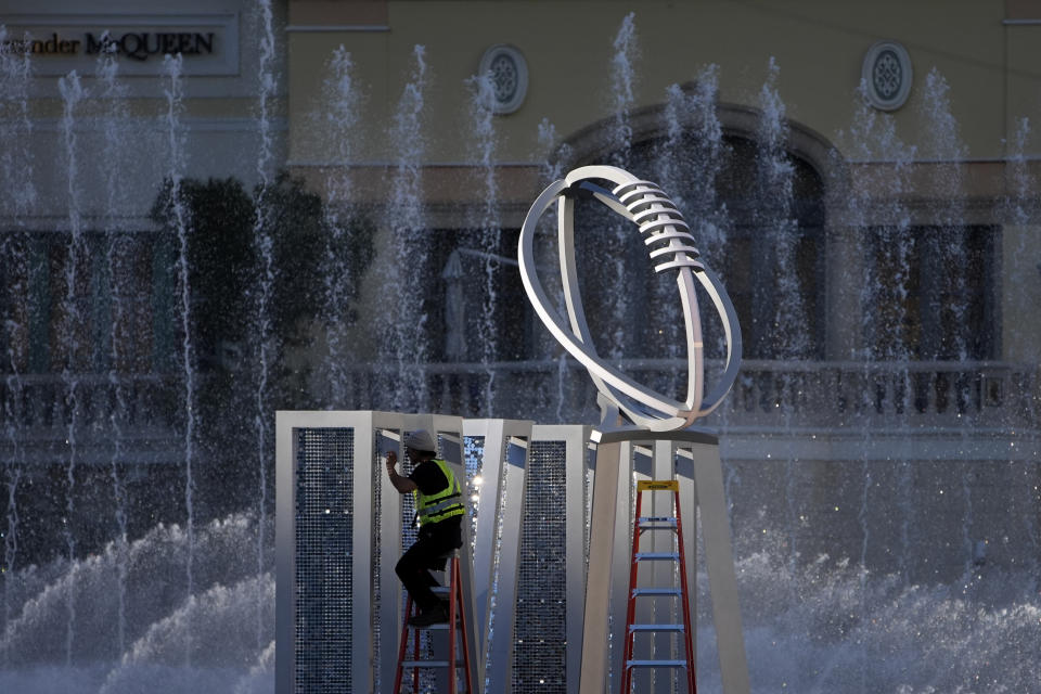 A worker erects a Lombardi Trophy statue at the Bellagio fountains ahead of the Super Bowl 58 football game, Friday, Feb. 2, 2024, in Las Vegas. Las Vegas is scheduled to host the Super Bowl 58 on Sunday, Feb. 11, 2024. (AP Photo/John Locher)