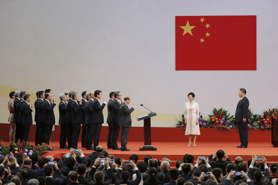 FILE - Chinese President Xi Jinping, right, administers the oath to Hong Kong's new Chief Executive Carrie Lam's new cabinet in office at the Hong Kong Convention and Exhibition Center in Hong Kong on July 1, 2017. Xi will visit Hong Kong this week to celebrate the 25th anniversary of the former British colony's 1997 return to China, a state news agency said Saturday, June 25, 2022, in his first trip outside the mainland since the start of the coronavirus pandemic 2 1/2 years ago. (AP Photo/Kin Cheung, File)