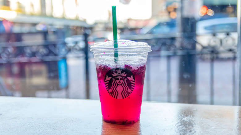 A pink Starbucks Refresher on a table