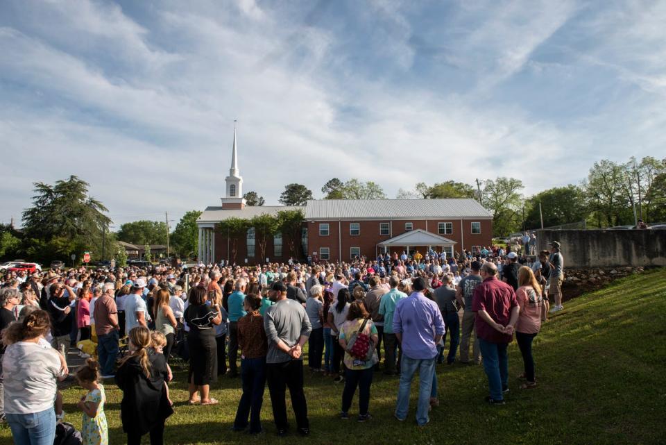 People gather for a prayer vigil at First Baptist Church in Dadeville, Ala., on April 16, 2023.