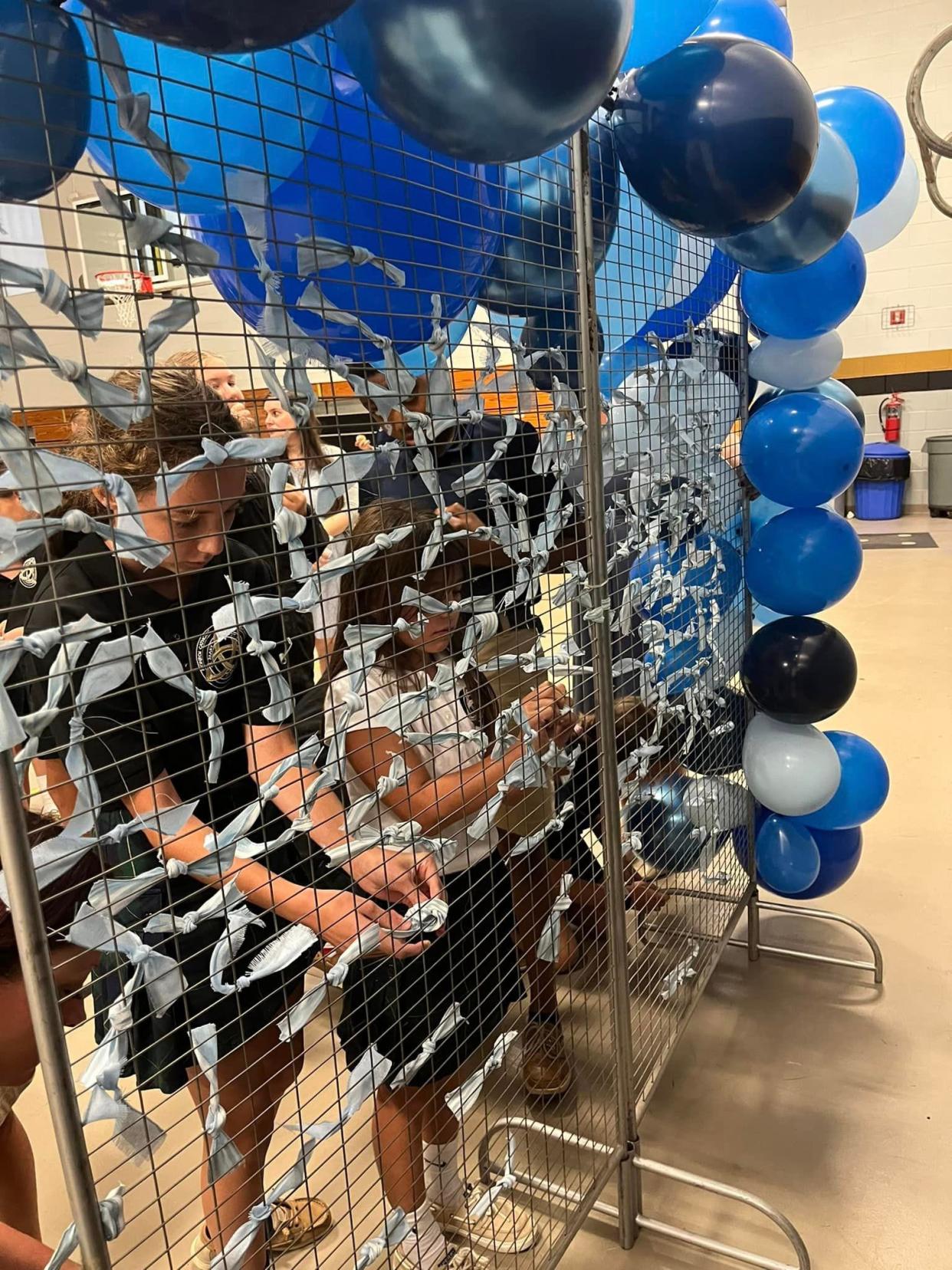 Each of St. Mary Middle School campus' 170 students tied a ribbon onto a gate during the ribbon-cutting event for the Kindness Room. Students were asked to think about someone who would benefit for a kind act and then pray for that person.