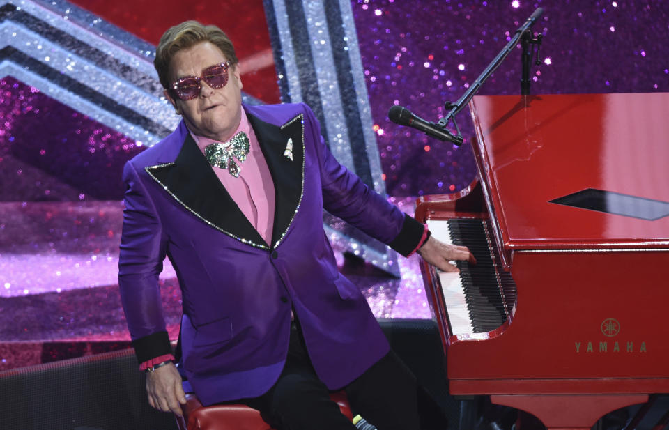 FILE - In a Sunday, Feb. 9, 2020 file photo, Elton John performs "(I'm Gonna) Love Me Again" nominated for the award for best original song from "Rocketman" at the Oscars, at the Dolby Theatre in Los Angeles. Elton John and the Foo Fighters announced cancellations Monday, March 16, for upcoming performances, joining other artists like The Who, Blake Shelton and Dan + Shay. (AP Photo/Chris Pizzello, File)