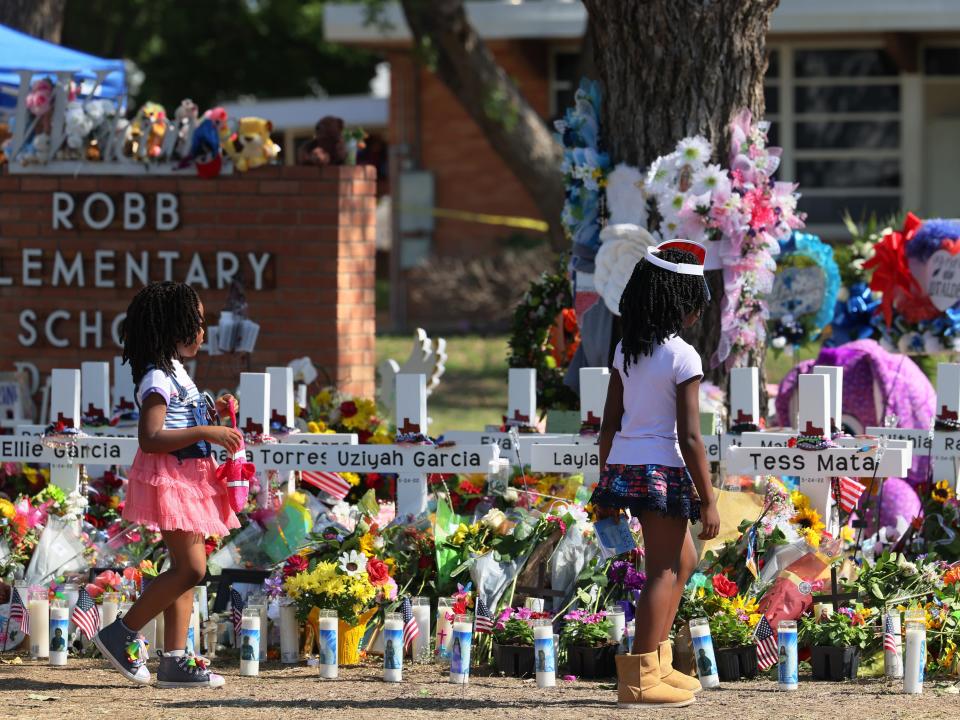 Young girls pay respect at a memorial for Uvalde shooting