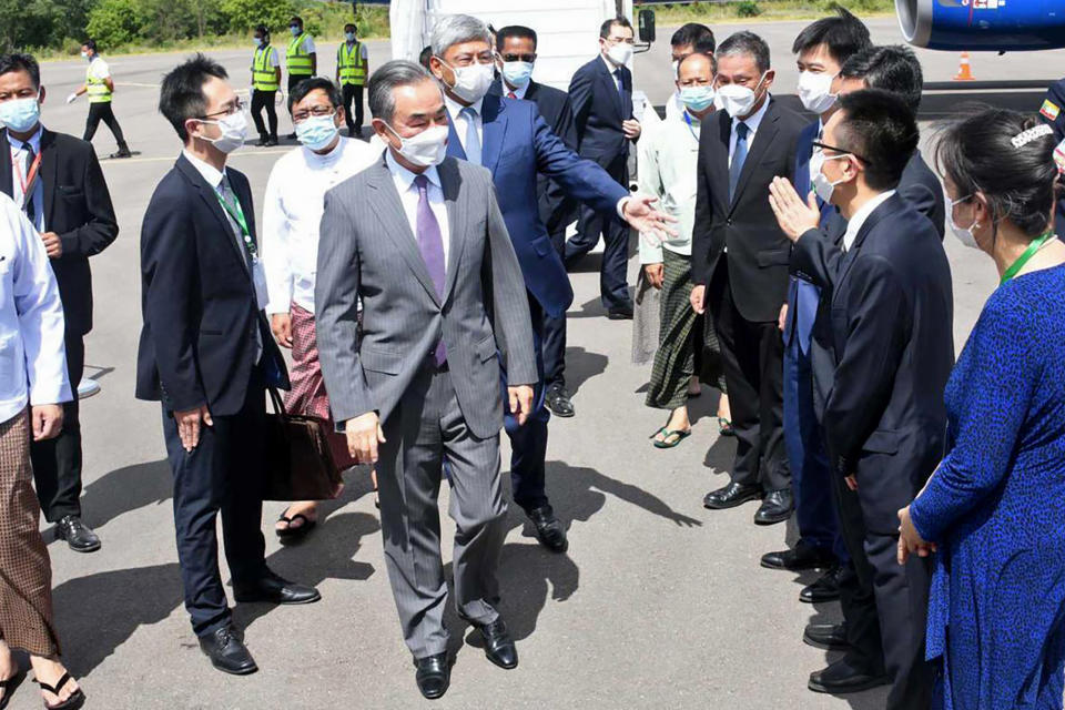 FILE - In this photo provided by the Myanmar Ministry of Information, Chinese Foreign Minister Wang Yi, center, is welcomed by Myanmar Foreign Ministry representatives and Chinese embassy officials upon his arrival at Nyaung Oo Airport in Bagan, Myanmar, Saturday July 2, 2022. A regional meeting between foreign ministers of China and some Southeast Asian countries took place in Myanmar Monday, July 4, 2022, hosted by the military government which claims that it was a recognition of its legitimacy but opponents protested as a violation of peace efforts. (Myanmar Ministry of Information via AP, File)