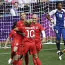 Canada's Christine Sinclair, center, is hugged by her teammate Lauren Sesselmann, after scoring during the group F women's soccer match between South Africa and Canada at the London 2012 Summer Olympics, in Coventry, England, Saturday, July 28, 2012. (AP Photo/Hussein Malla)