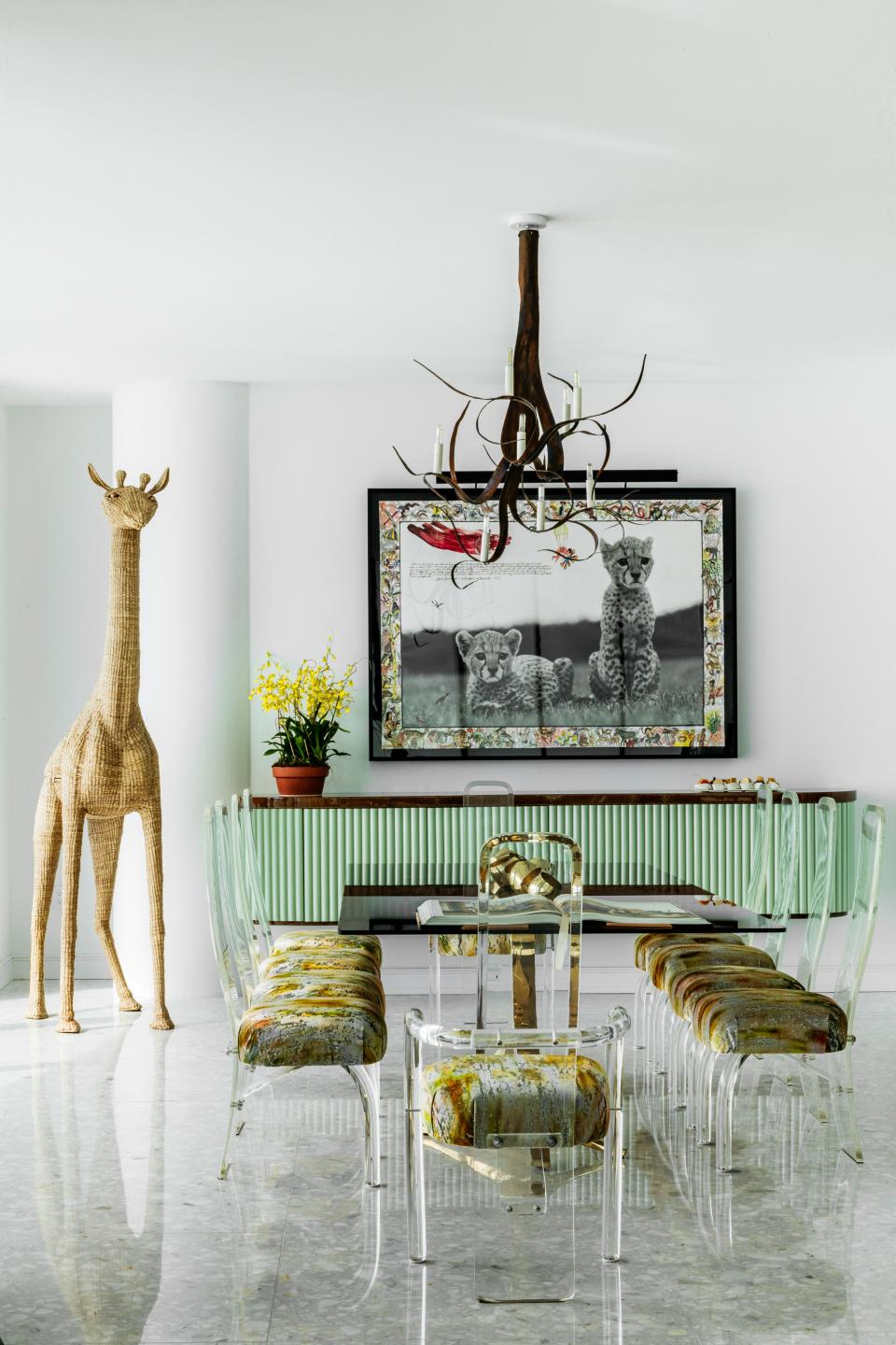 The dining area features a Peter Beard photograph and a bar in the shape of a giraffe.