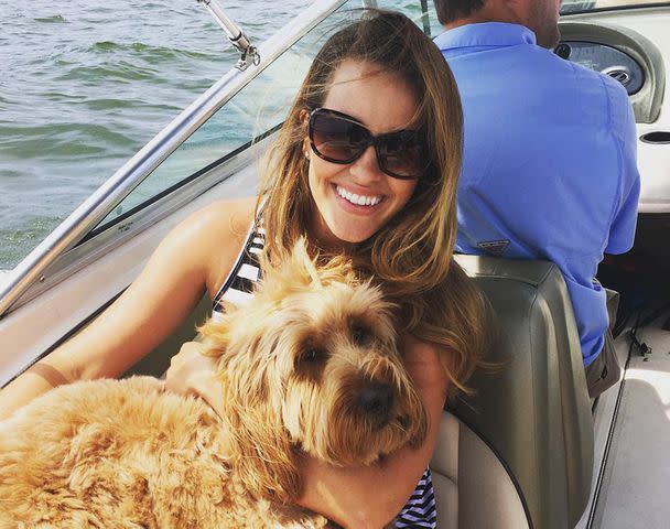 <p>Julie Cousins Instagram</p> Julie Hampton smiling with her dog