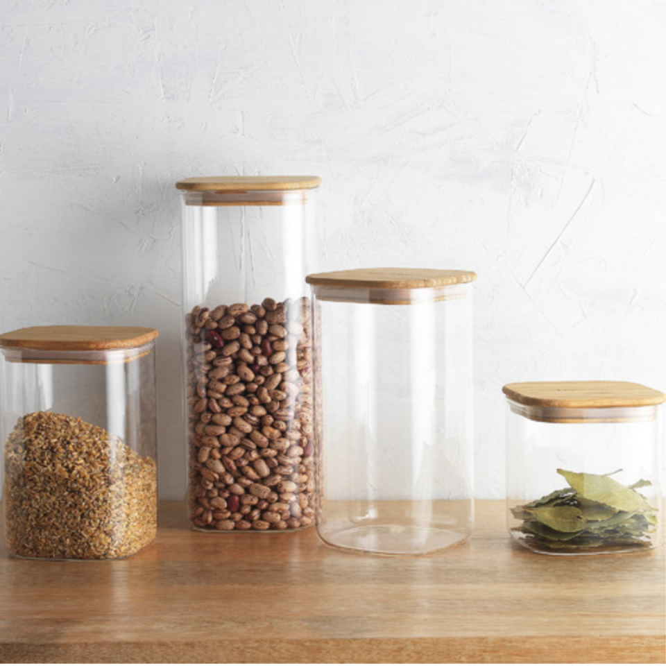 4 Piece Ecology Pantry Square Glass Canister with Bamboo Lid Set from Temple & Webster containing beans and barley and bay leaves.