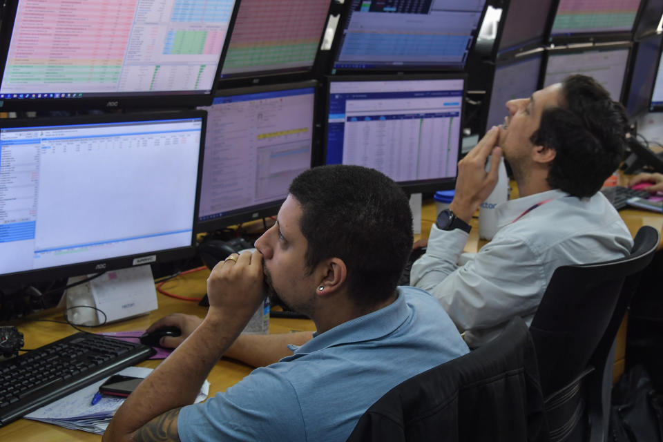 Traders work at the Necton brokerage company in Sao Paulo, Brazil on March 13, 2020. - Brazilian stocks rebounded Friday after days of carnage caused by the coronavirus pandemic, following European markets higher to partially recover their losses. The Sao Paulo stock exchange's Ibovespa index surged more than 14 percent at opening, but then settled to a gain of about seven percent, after losing 14.78 percent Thursda (Photo by NELSON ALMEIDA / AFP) / The erroneous mention[s] appearing in the metadata of this photo by NELSON ALMEIDA has been modified in AFP systems in the following manner: [Traders work at the Necton Brokerage Company] instead of [Traders work at the Sao Paulo stock exchange]. Please immediately remove the erroneous mention[s] from all your online services and delete it (them) from your servers. If you have been authorized by AFP to distribute it (them) to third parties, please ensure that the same actions are carried out by them. Failure to promptly comply with these instructions will entail liability on your part for any continued or post notification usage. Therefore we thank you very much for all your attention and prompt action. We are sorry for the inconvenience this notification may cause and remain at your disposal for any further information you may require. (Photo by NELSON ALMEIDA/AFP via Getty Images)