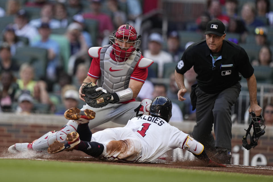 Philadelphia Phillies catcher J.T. Realmuto (10) tags out Atlanta Braves' Ozzie Albies (1) in the first inning of a baseball game, Sunday, May 28, 2023, in Atlanta. (AP Photo/Brynn Anderson)