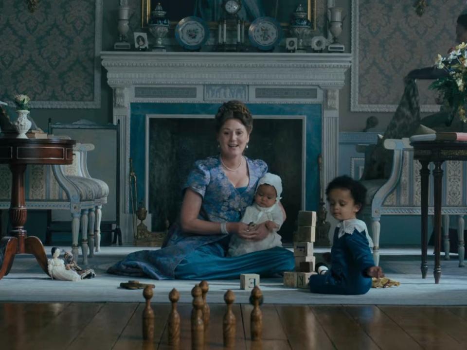 Violet Bridgerton playing with two babies.