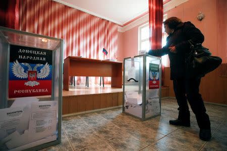 A woman casts a ballot during the self-proclaimed Donetsk People's Republic leadership and local parliamentary elections at a polling station in the coastal settlement of Sedovo, south from Donetsk November 2, 2014. REUTERS/Maxim Zmeyev