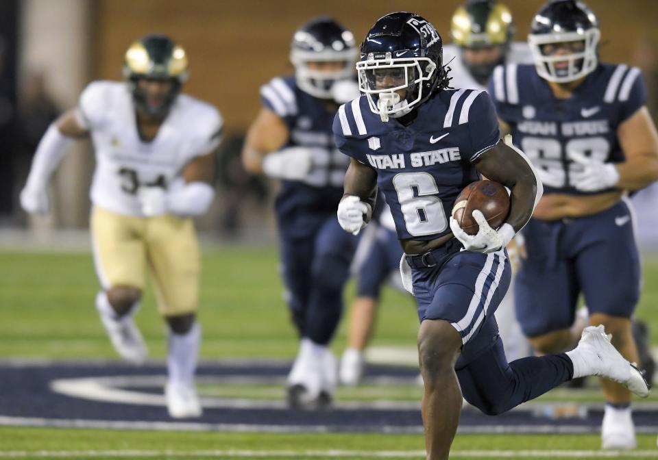 Utah State running back Davon Booth (6) carries the ball for a touchdown against Colorado State during the second half of an NCAA college football game Saturday, Oct. 7, 2023, in Logan, Utah. | Eli Lucero/The Herald Journal via AP