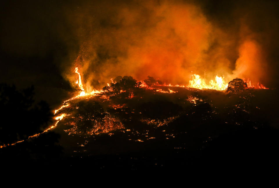 A fire burns on the hill East of Centerville early Friday, Aug. 30, 2019.Three homes were destroyed and anther eight were impacted with fire damage. An additional 400 homes have been evacuated in the Centerville area. (Colter Peterson/The Deseret News via AP)